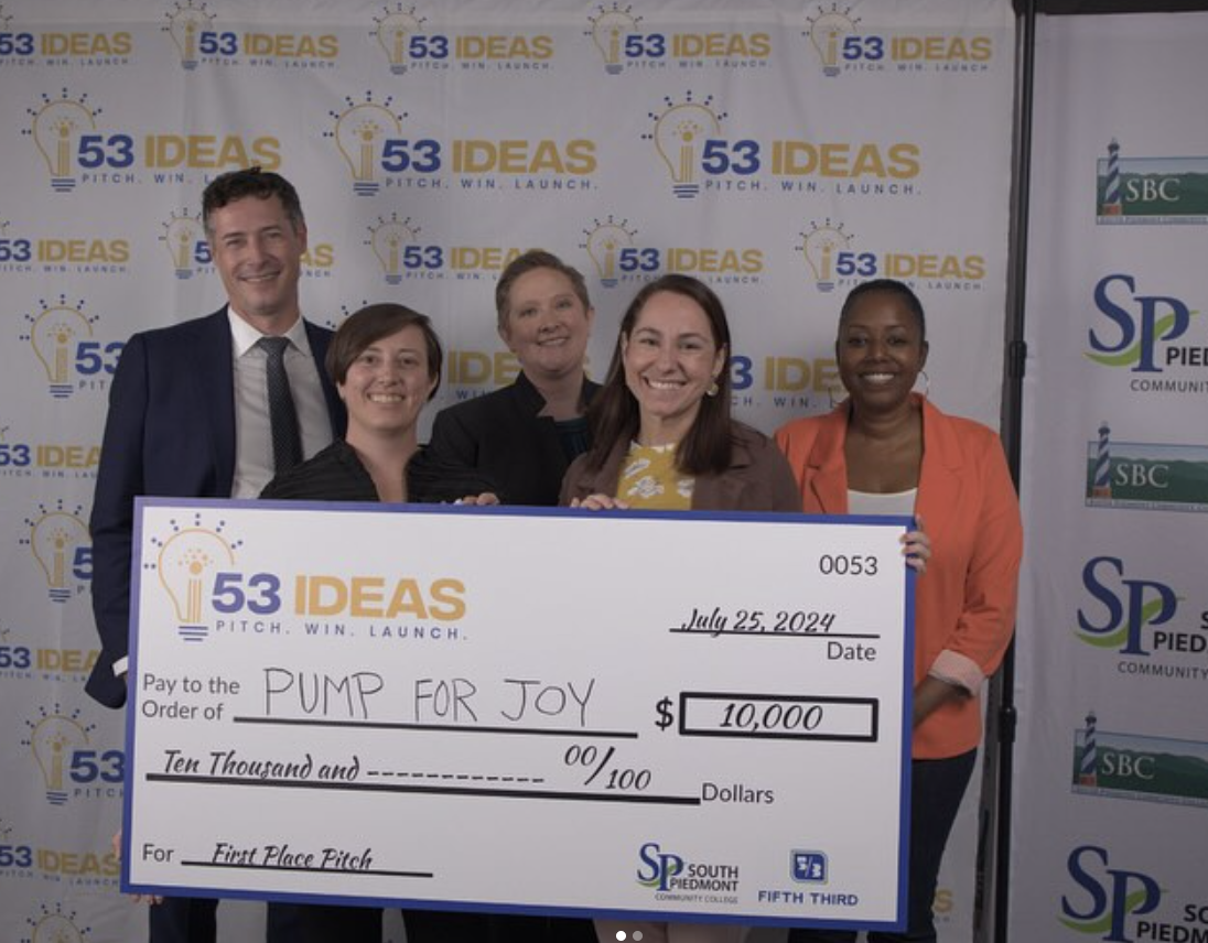 The Pump For Joy team accepting a first place pitch award check