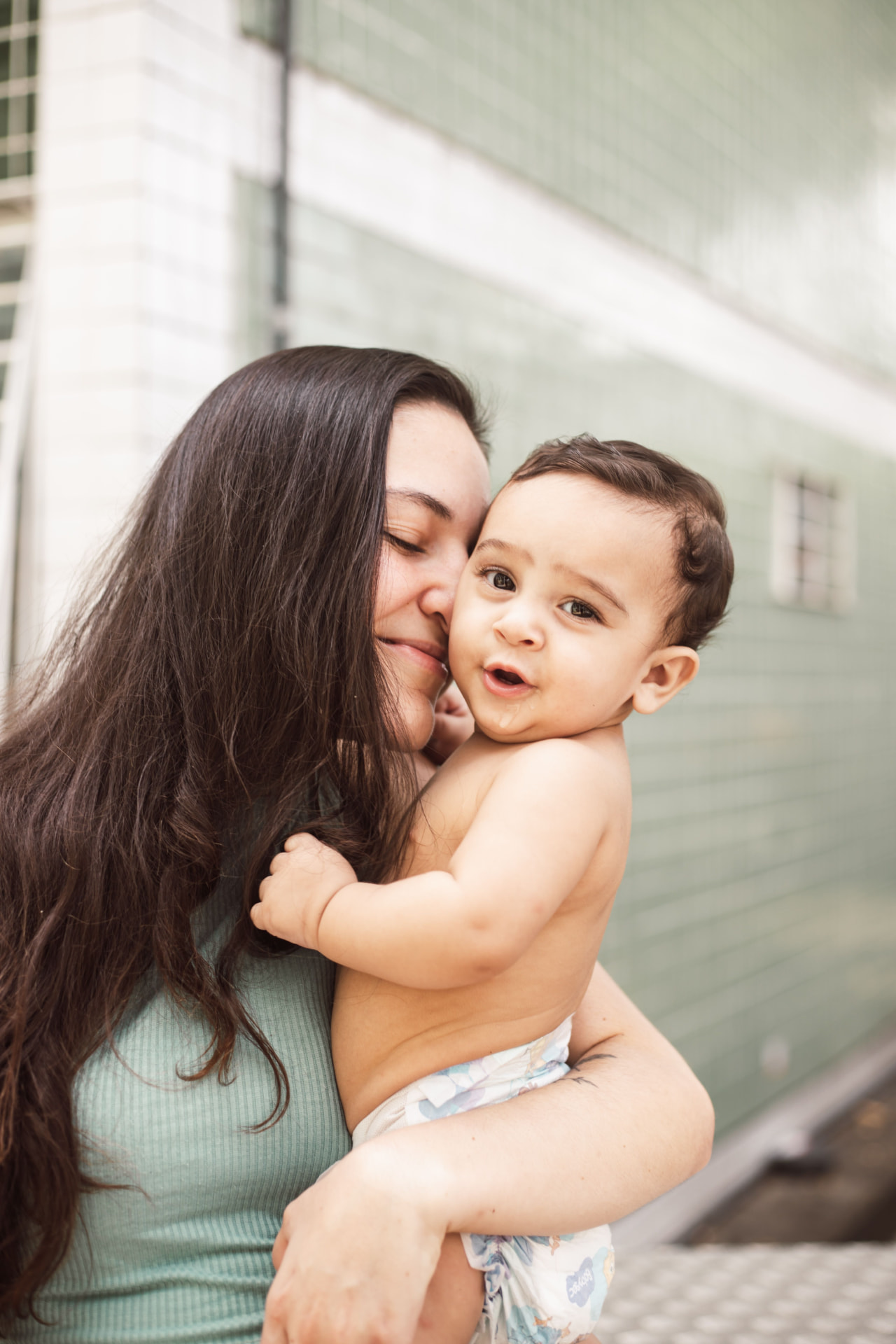 A parent holding their baby in a calm, everyday moment